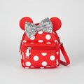 Red polka dot bag with Minnie Mouse ears and bow on a white background