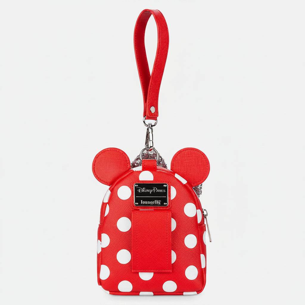 Red polka dot backpack with a strap on a white background