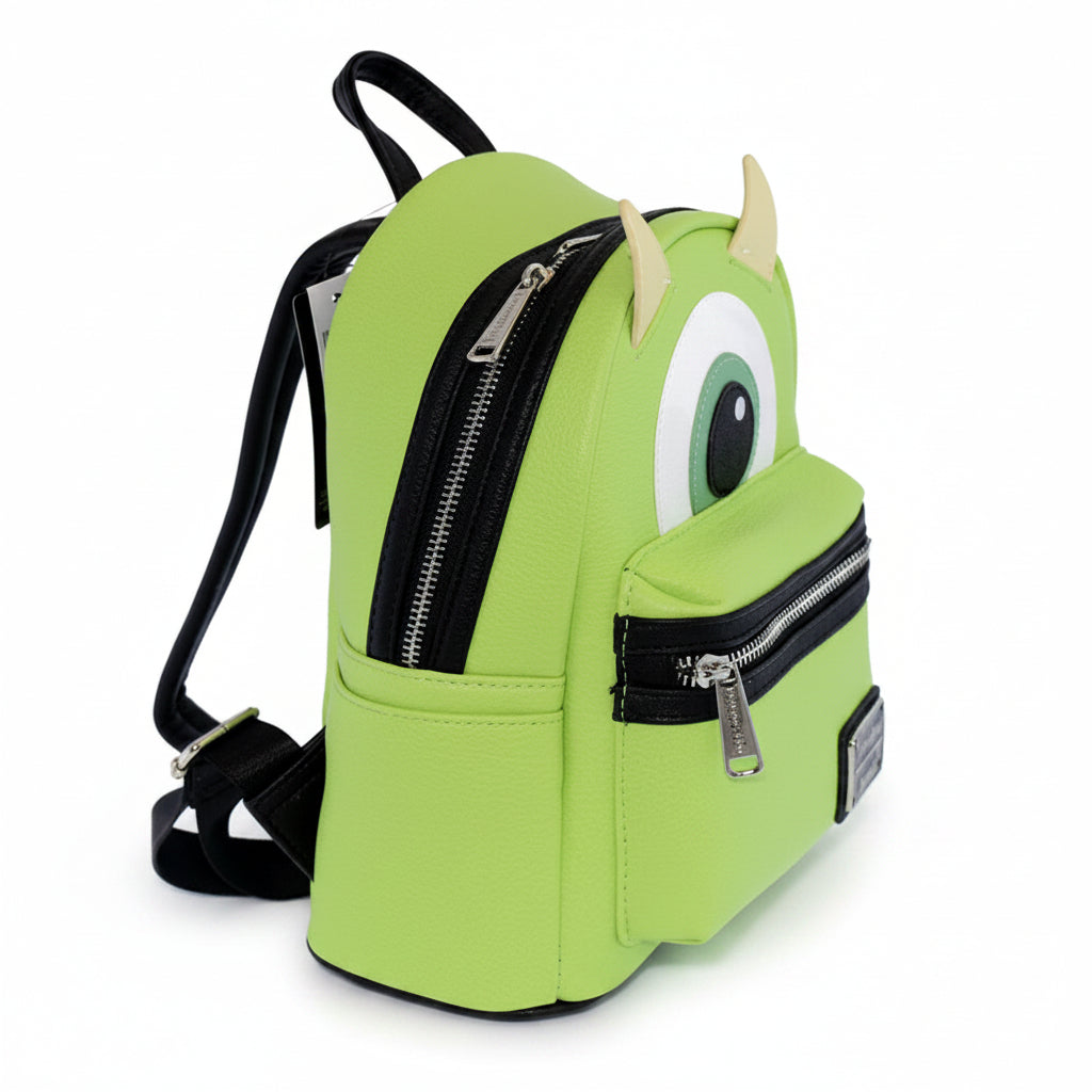 Green backpack with cartoon face design on a white background